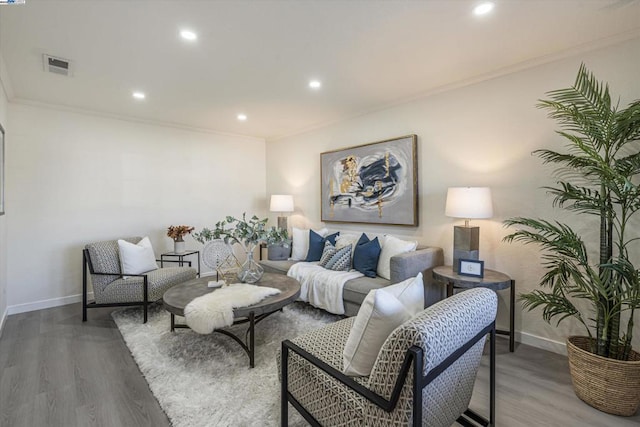 living room with crown molding and hardwood / wood-style floors