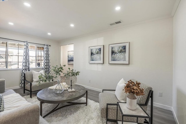 living room with hardwood / wood-style flooring and crown molding