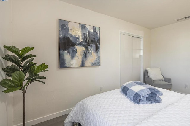 bedroom featuring hardwood / wood-style floors and a closet