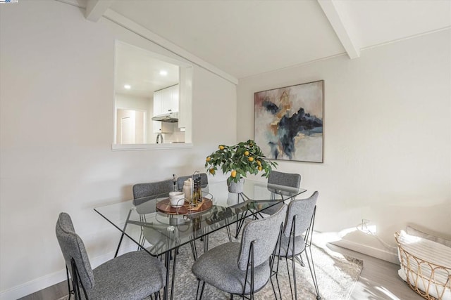 dining area with hardwood / wood-style floors and beam ceiling