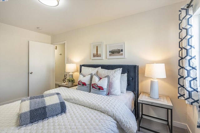 bedroom featuring multiple windows and hardwood / wood-style flooring