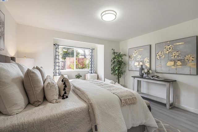 bedroom with wood-type flooring