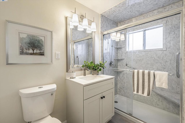 bathroom with vanity, toilet, and walk in shower