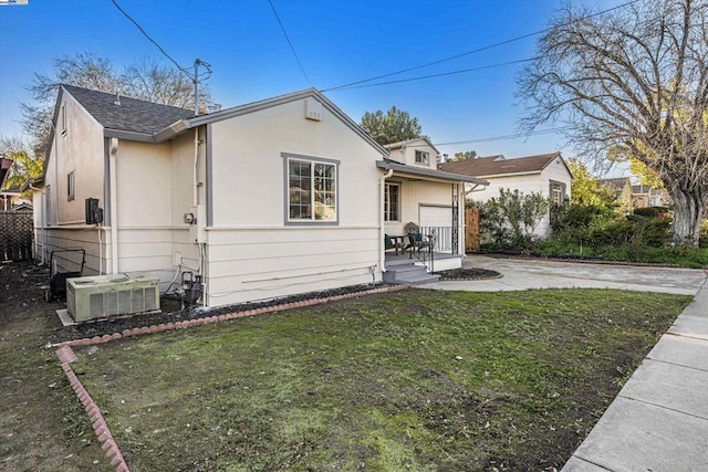 view of side of home featuring a yard and central air condition unit