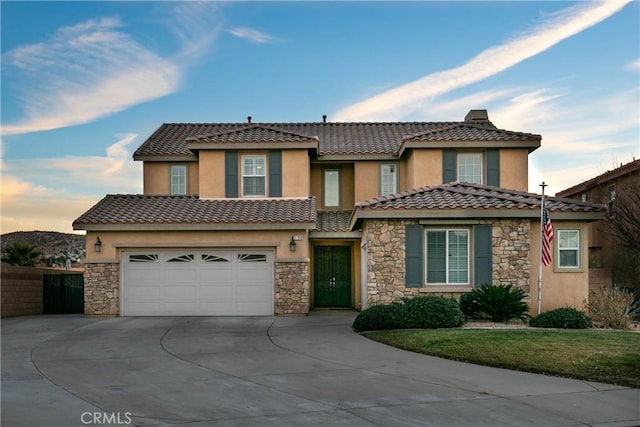 mediterranean / spanish-style home with a garage