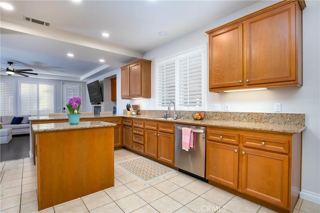 kitchen with kitchen peninsula, dishwasher, sink, light stone counters, and ceiling fan