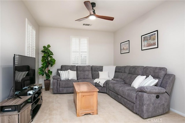 living room with ceiling fan and light colored carpet