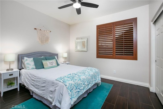 bedroom with a closet, dark hardwood / wood-style floors, and ceiling fan