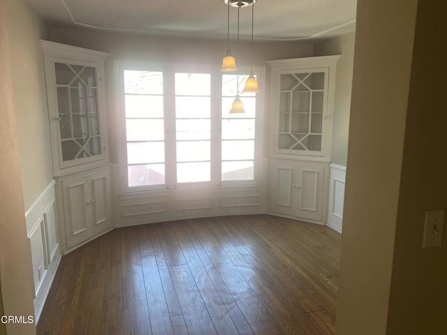 unfurnished dining area featuring dark hardwood / wood-style floors