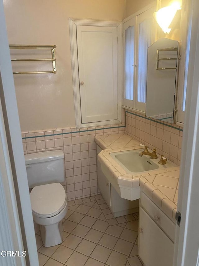 bathroom with tile patterned flooring, vanity, and toilet