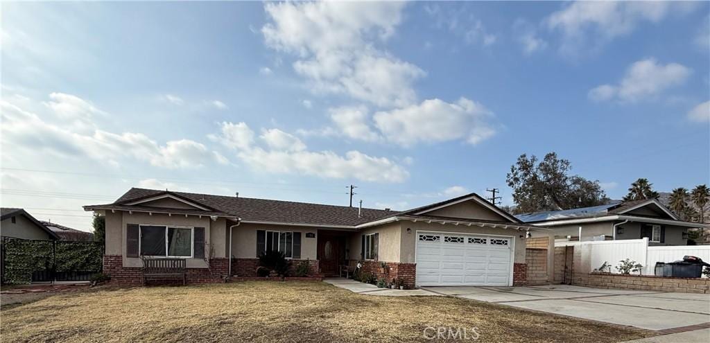 ranch-style house with a garage and a front yard