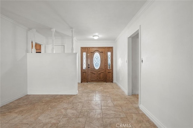 foyer entrance with ornamental molding and baseboards