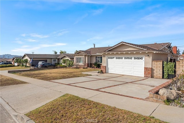 ranch-style house with brick siding, concrete driveway, an attached garage, a front yard, and a residential view