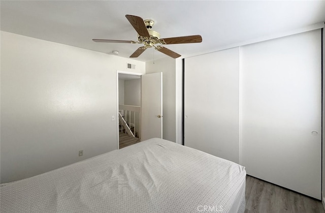 bedroom with ceiling fan and light hardwood / wood-style floors