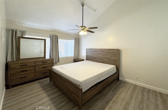 bedroom with lofted ceiling, hardwood / wood-style flooring, and ceiling fan