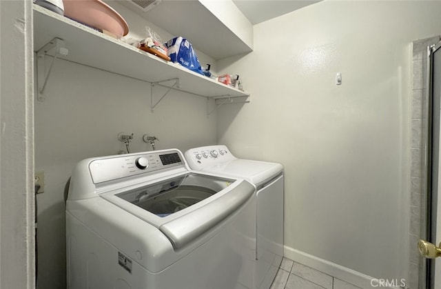 laundry room featuring light tile patterned flooring and independent washer and dryer