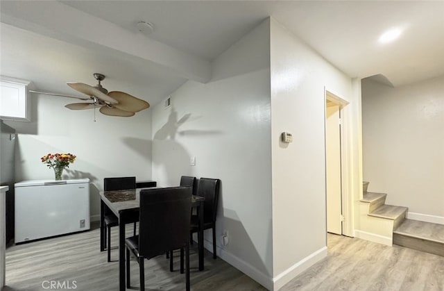 dining room featuring ceiling fan, lofted ceiling with beams, and light wood-type flooring