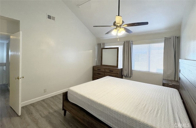 bedroom with ceiling fan, wood-type flooring, and vaulted ceiling