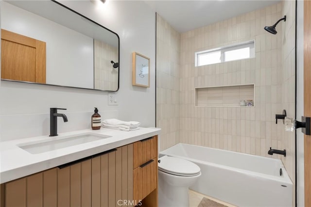 full bathroom with tiled shower / bath, vanity, and toilet