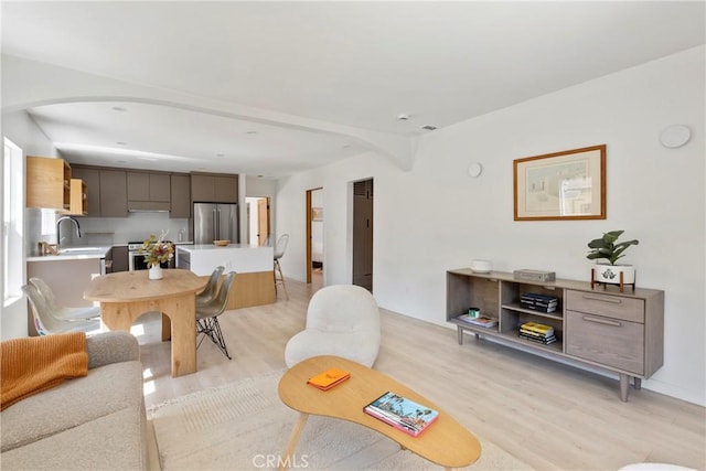 living room with sink and light wood-type flooring