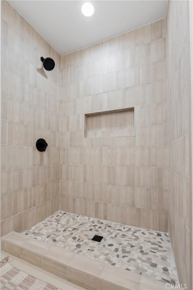 bathroom with tiled shower