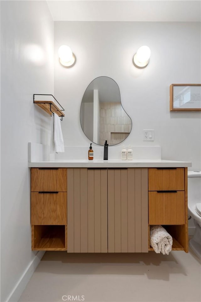 bathroom featuring vanity and toilet