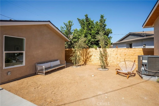 view of yard featuring central AC unit and a patio area