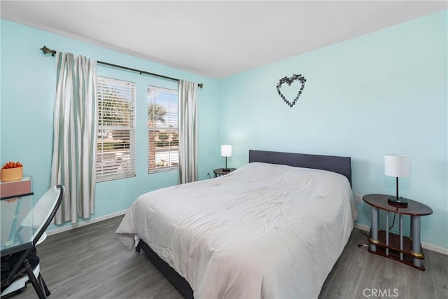 bedroom with dark hardwood / wood-style flooring