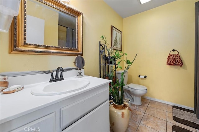 bathroom with vanity, tile patterned floors, and toilet