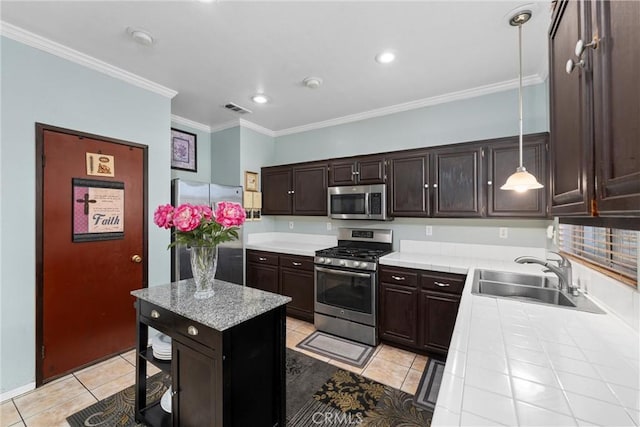 kitchen with sink, hanging light fixtures, stainless steel appliances, dark brown cabinetry, and ornamental molding