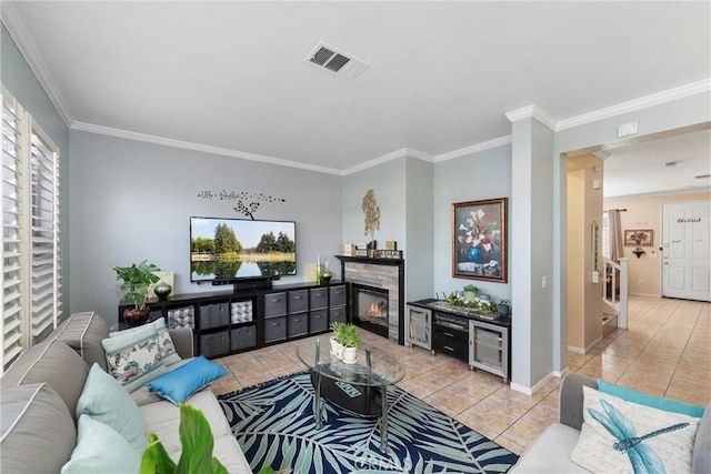 living room with light tile patterned floors and crown molding