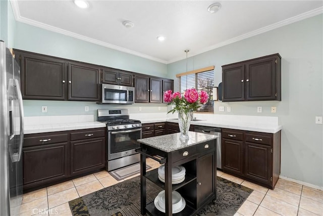 kitchen featuring crown molding, appliances with stainless steel finishes, dark brown cabinets, and pendant lighting