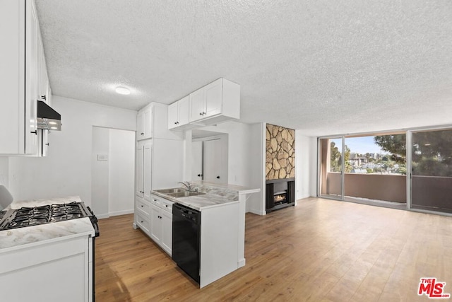 kitchen featuring sink, stainless steel gas stove, white cabinetry, black dishwasher, and light hardwood / wood-style floors