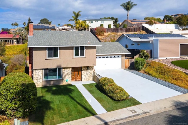 view of front of home featuring a garage and a front yard