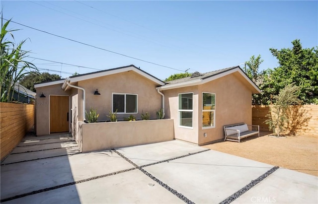 back of property with a patio area