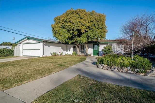 ranch-style house featuring a garage and a front lawn