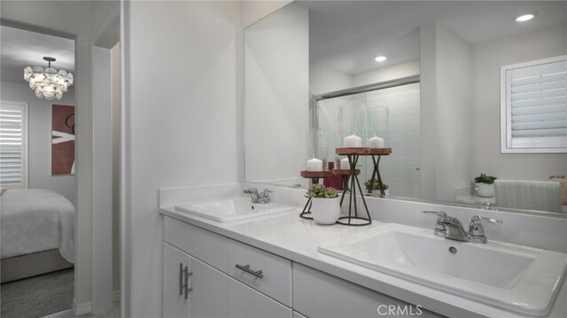 bathroom with vanity and a shower with shower door