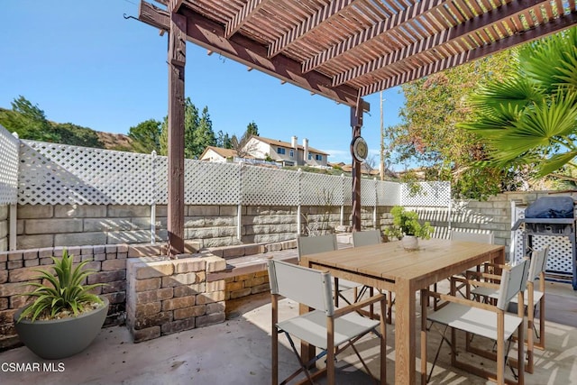 view of patio featuring area for grilling and a pergola