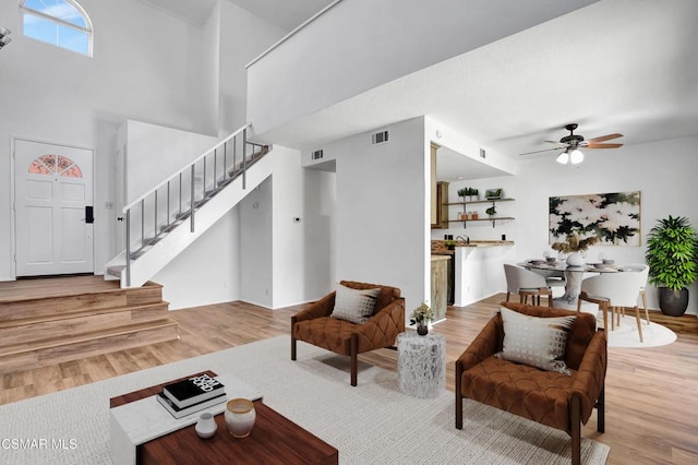 living room with wood-type flooring and ceiling fan