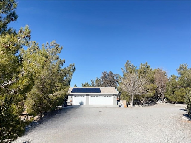 view of front of property featuring solar panels