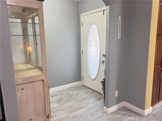 foyer entrance with light hardwood / wood-style flooring