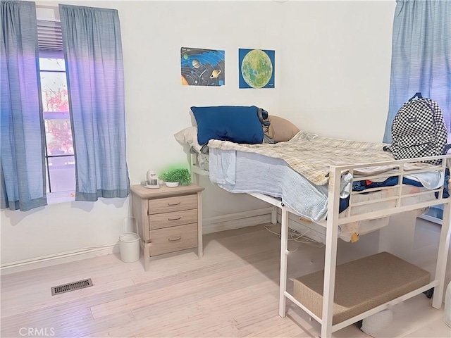 bedroom with light wood-type flooring