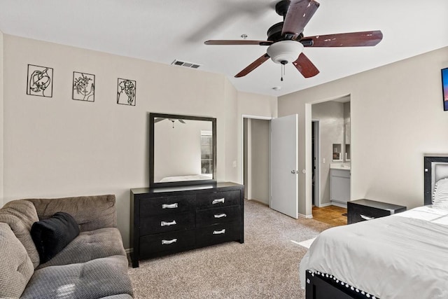 carpeted bedroom with ceiling fan and connected bathroom