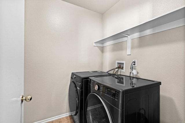 clothes washing area featuring washer and dryer