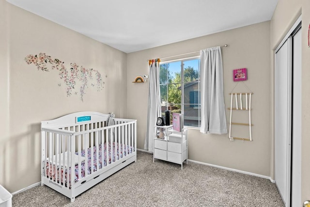 carpeted bedroom with a crib and a closet