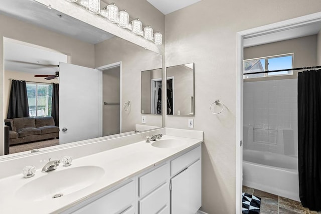 bathroom featuring shower / tub combo, vanity, a healthy amount of sunlight, and ceiling fan