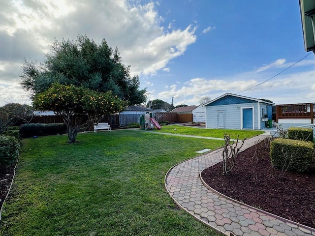 view of yard featuring a playground and an outdoor structure