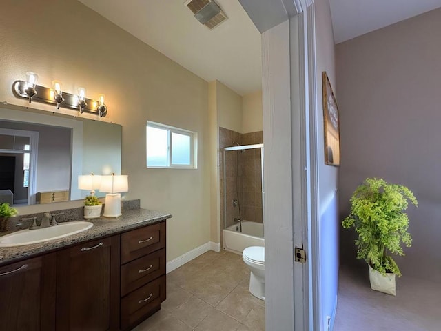 full bathroom featuring tiled shower / bath combo, vanity, tile patterned floors, and toilet