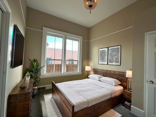 bedroom featuring dark colored carpet