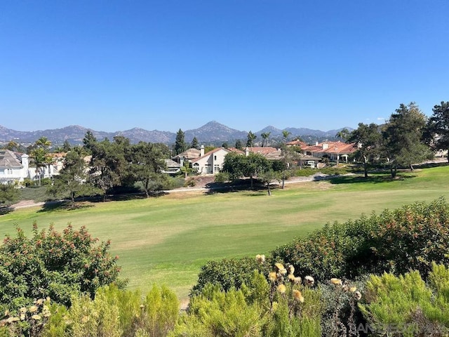 view of property's community with a mountain view and a yard